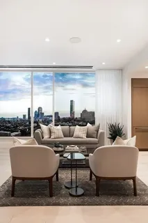 a living room with furniture a large window and a table