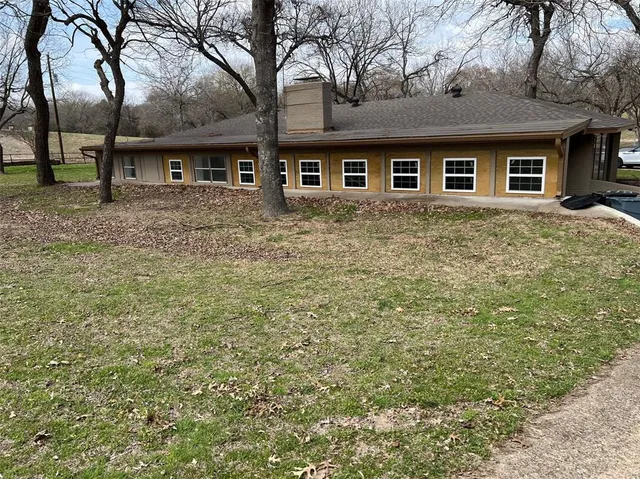 a view of a house with a yard covered with snow in front of house