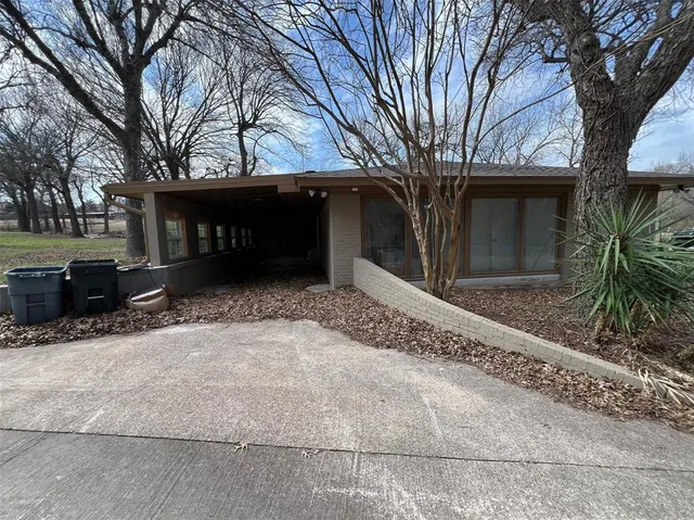 a backyard of a house with table and chairs