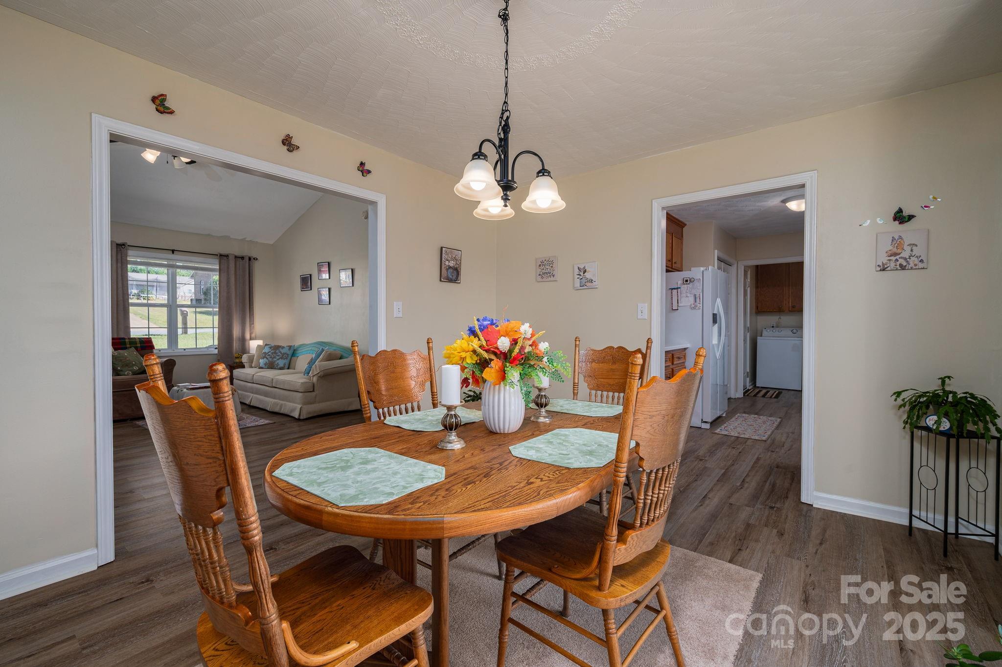 1371 Millrace Drive Conover, NC 28613 - Photo 11 of 36 a dining room with furniture potted plants and wooden floor