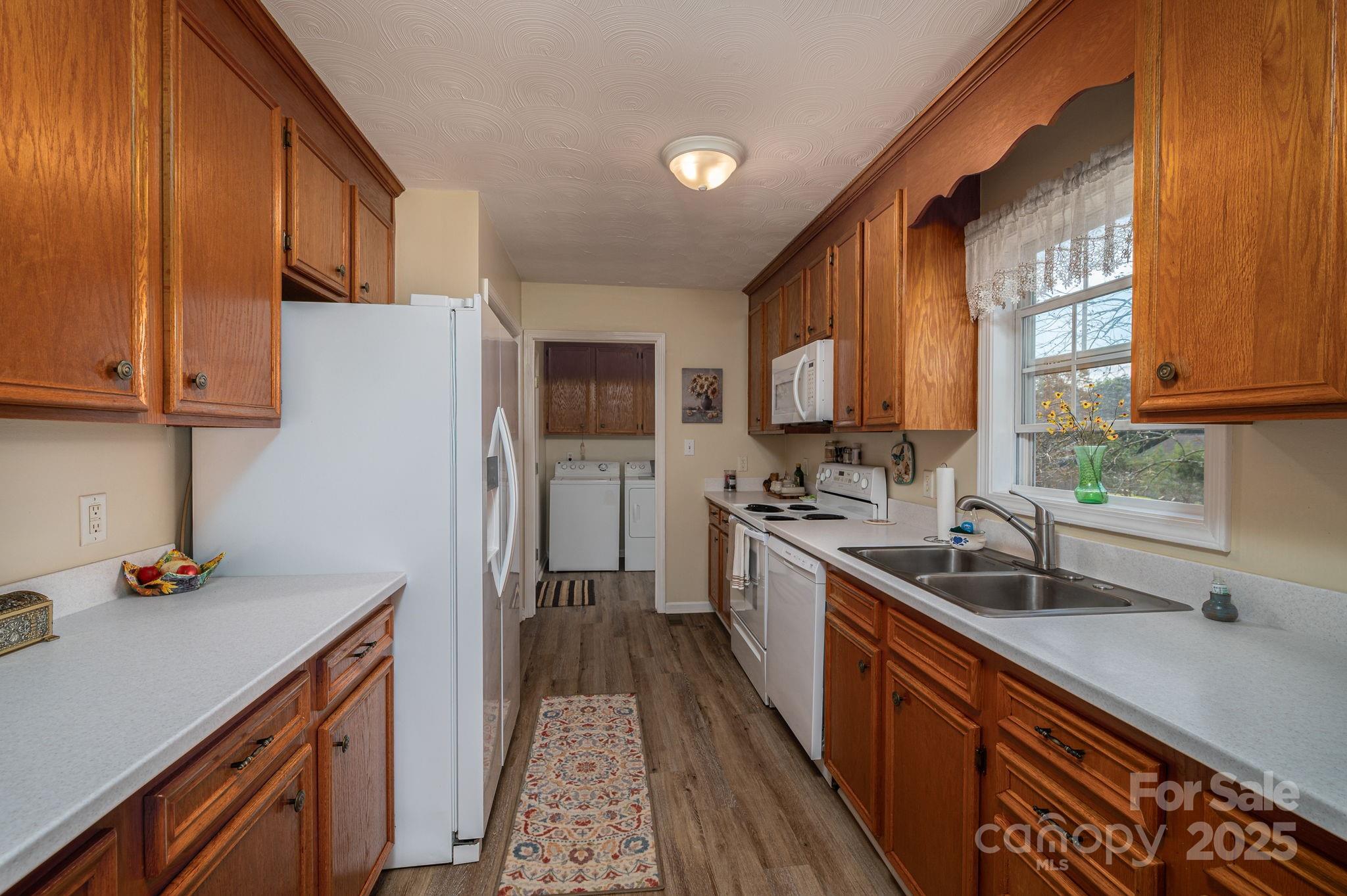 1371 Millrace Drive Conover, NC 28613 - Photo 12 of 36 a kitchen with stainless steel appliances granite countertop a sink stove and refrigerator
