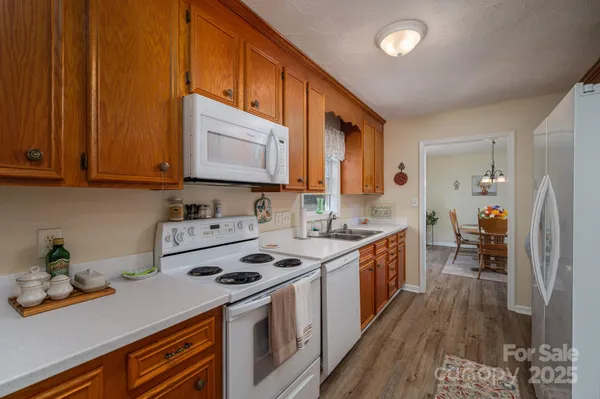 a kitchen with a stove a sink and a refrigerator