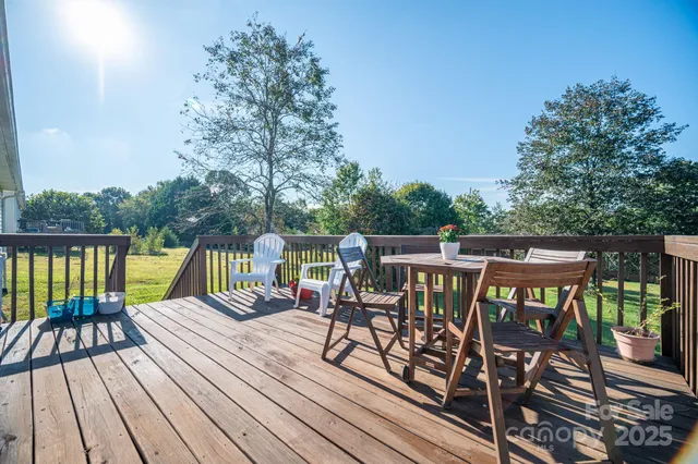 a view of a patio on wooden deck and mountain view