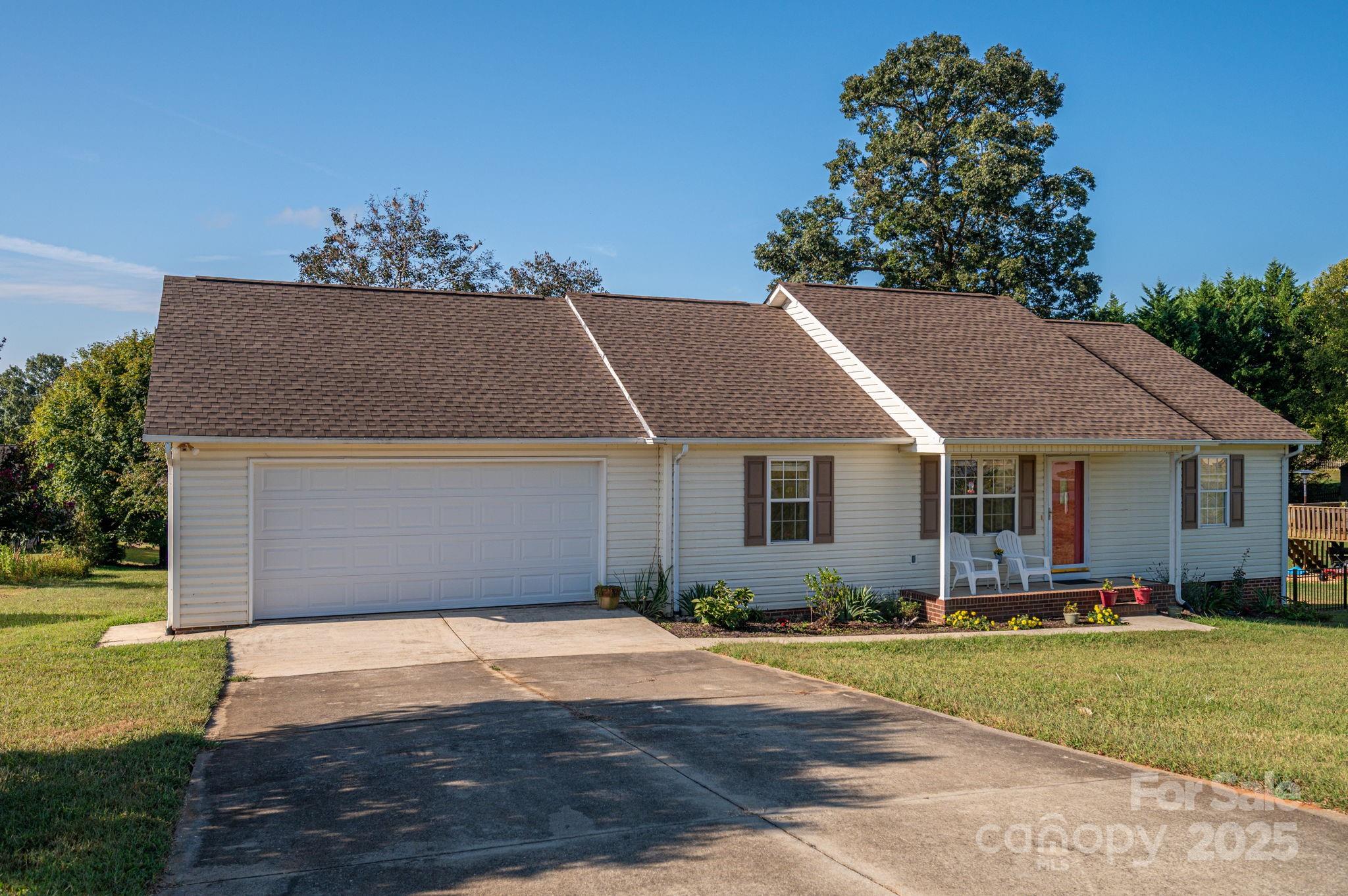 1371 Millrace Drive Conover, NC 28613 - Photo 4 of 36 a front view of a house with a yard and garage