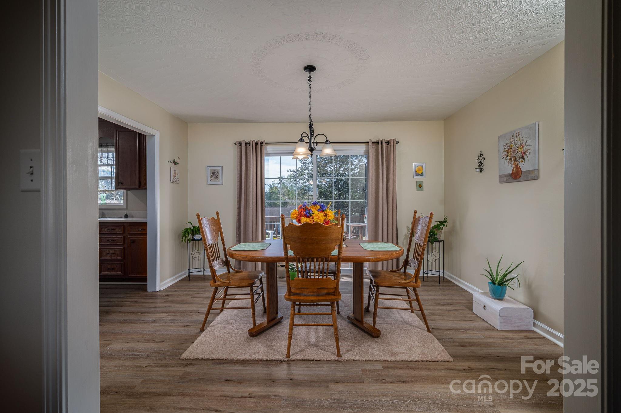 1371 Millrace Drive Conover, NC 28613 - Photo 9 of 36 a dining room with furniture a chandelier and wooden floor