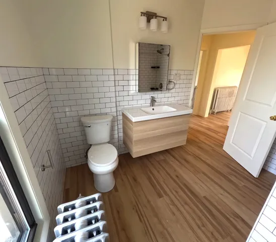 a bathroom with a toilet a sink and a mirror