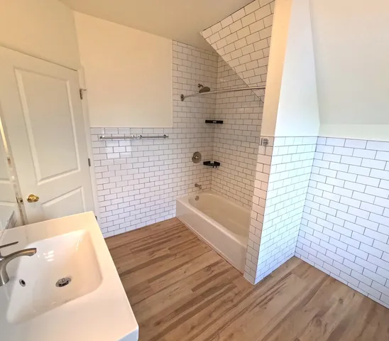a bathroom with a bathtub and shower