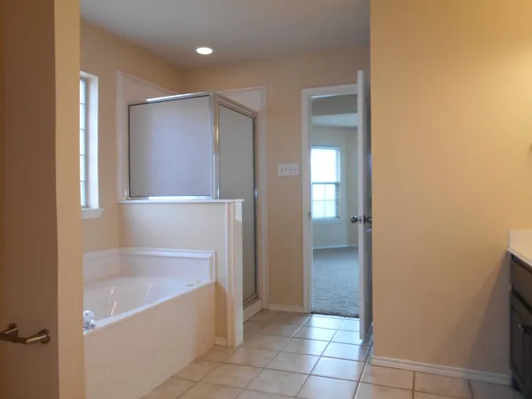 a bathroom with a bathtub and a shower
