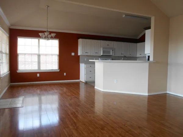 a room with hard wood floors and a window