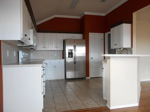 a kitchen with stainless steel appliances a refrigerator and a stove