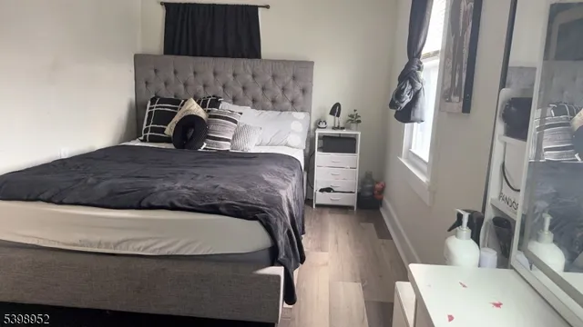 a bedroom with a bed and a mirror