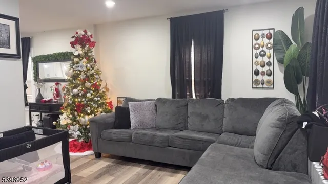 a living room with furniture and a christmas tree