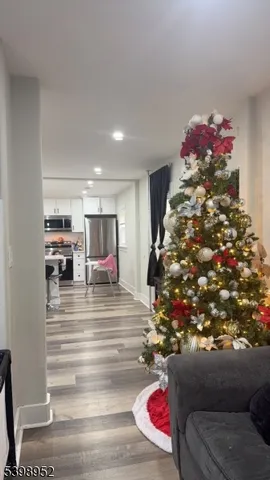 a room with lots of white furniture and a chandelier