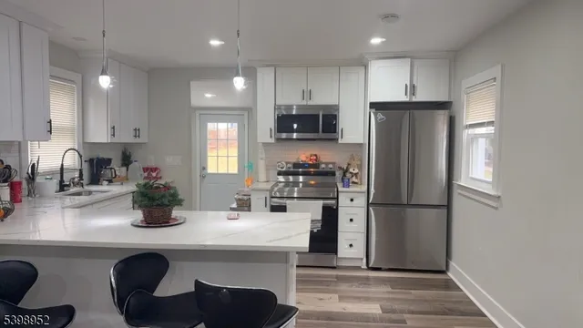 a kitchen with refrigerator and cabinets
