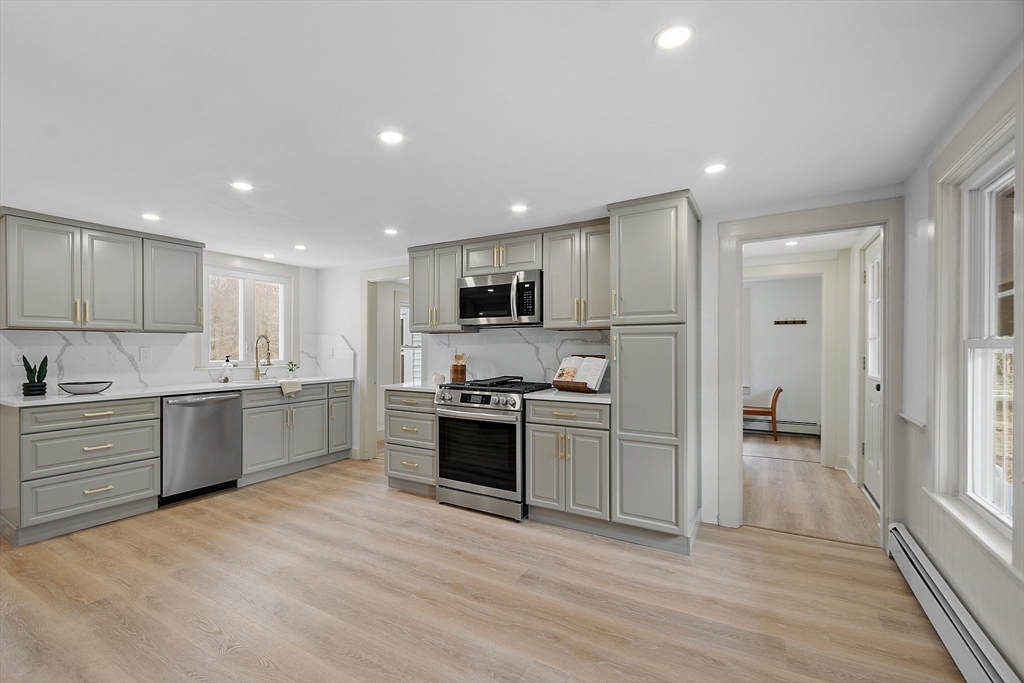 453 Main Street Northborough, MA 01532 - Photo 13 of 42 a large kitchen with a stove a sink dishwasher a refrigerator and a oven with wooden floor
