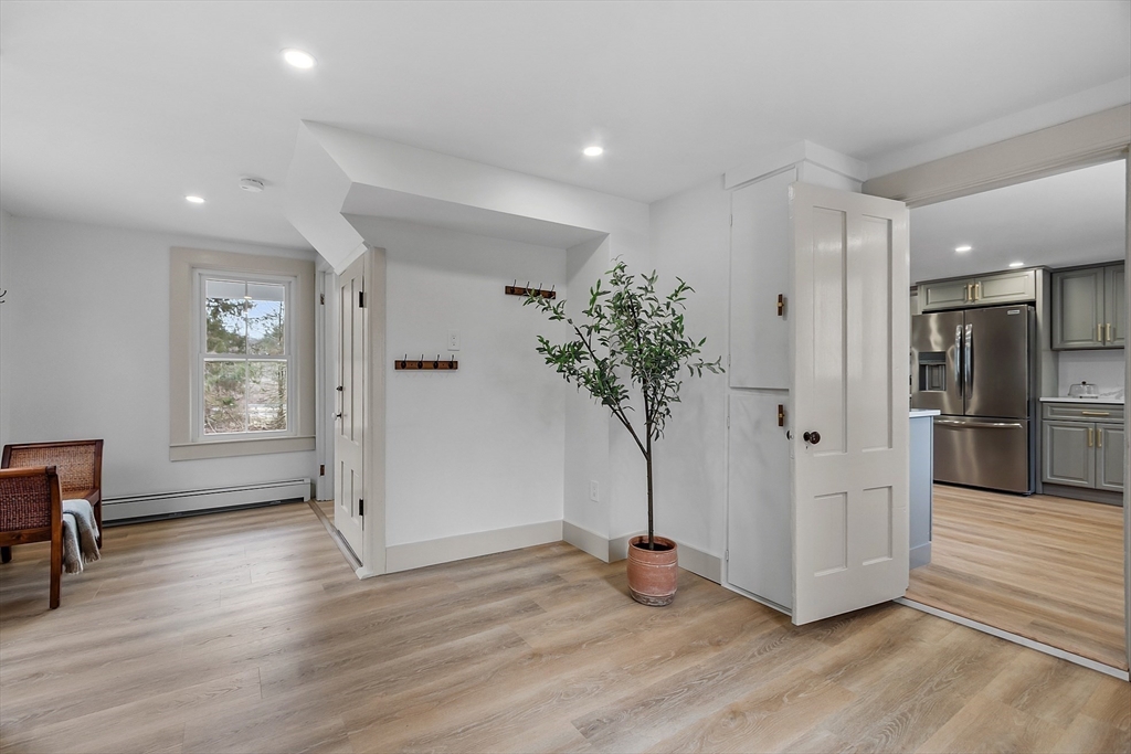 453 Main Street Northborough, MA 01532 - Photo 15 of 42 a view of a hallway with wooden floor and a potted plant