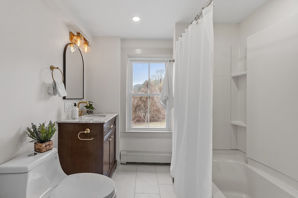 453 Main Street Northborough, MA 01532 - Photo 20 of 42 a bathroom with a granite countertop sink toilet and shower