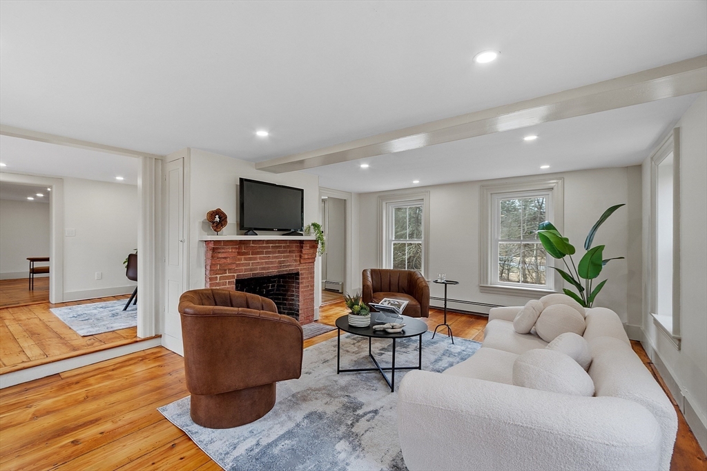 453 Main Street Northborough, MA 01532 - Photo 23 of 42 a living room with furniture a fireplace and a potted plant