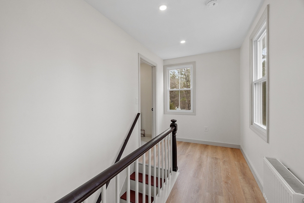 453 Main Street Northborough, MA 01532 - Photo 24 of 42 a view of a hallway with wooden floor and staircase