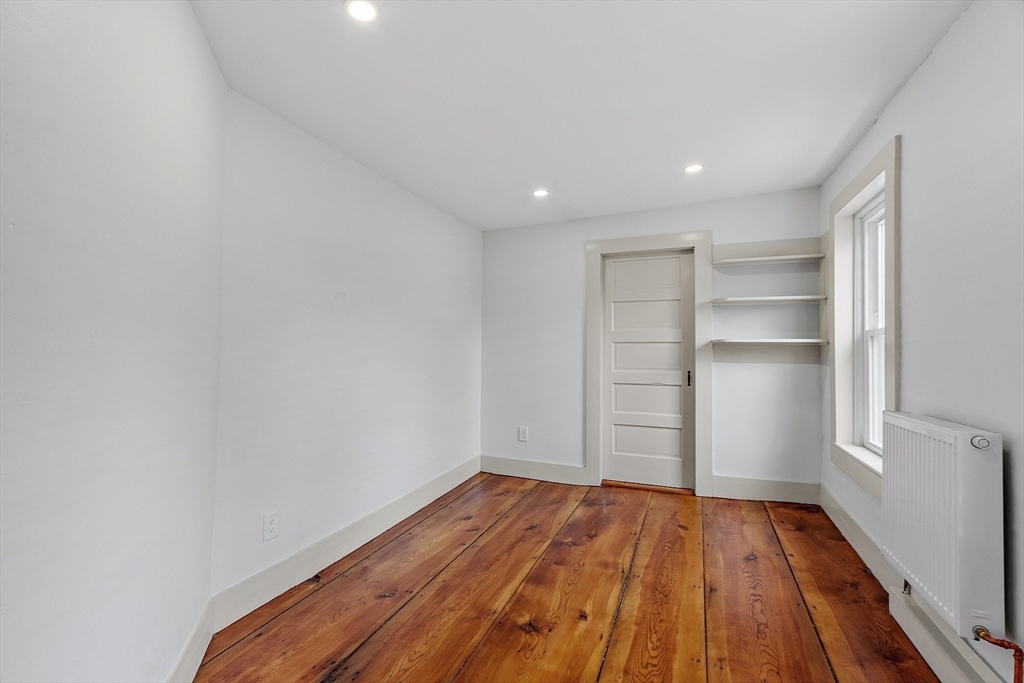 453 Main Street Northborough, MA 01532 - Photo 25 of 42 a view of a room with wooden floor and empty racks