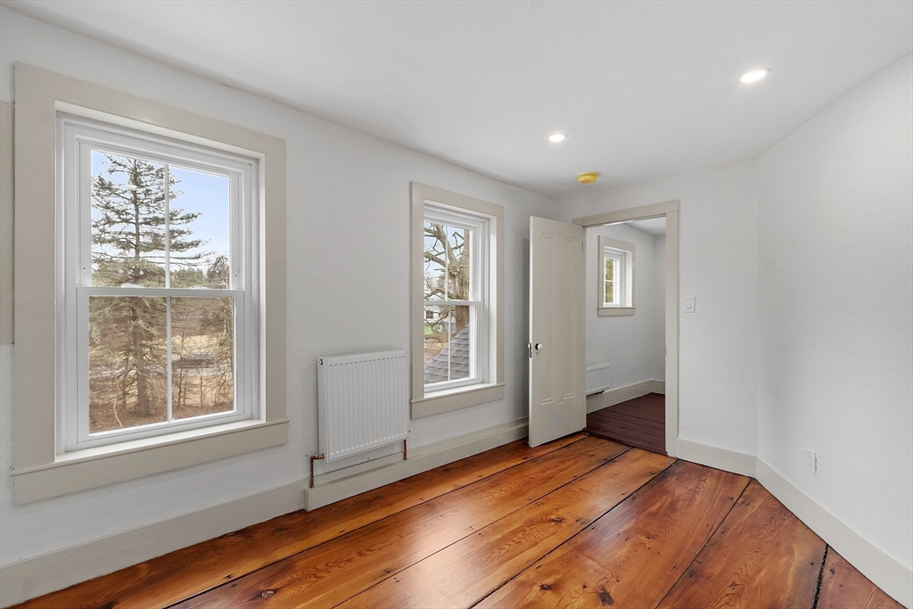 453 Main Street Northborough, MA 01532 - Photo 26 of 42 a bedroom with wooden floor and windows