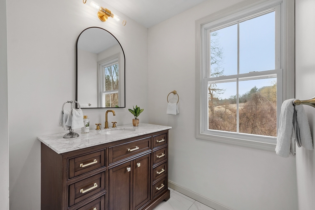 453 Main Street Northborough, MA 01532 - Photo 35 of 42 a bathroom with a sink a mirror and a window