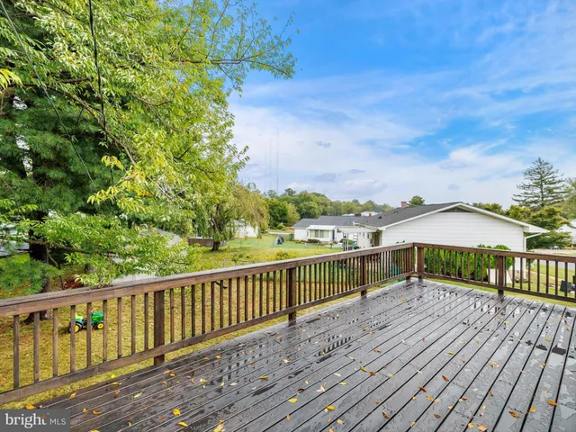 a view of a wooden deck with a yard