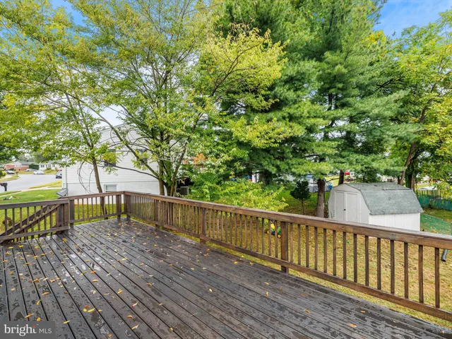 a view of a wooden deck with a yard