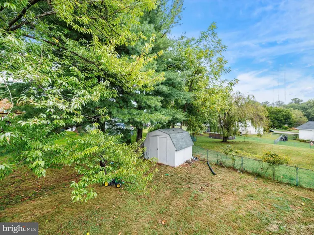 a backyard of a house with a yard and outdoor seating