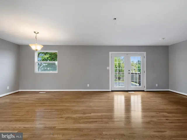 a view of room with window and wooden floor
