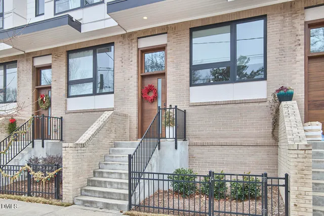 a view of a brick house with large windows