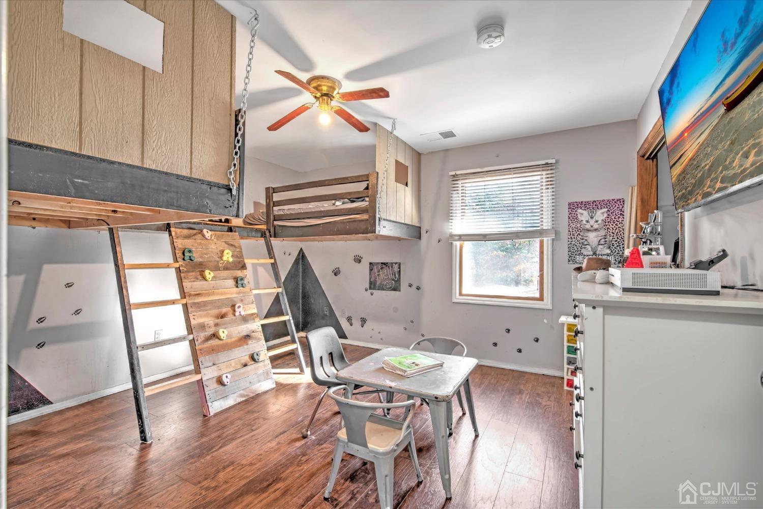 59 Sunnyside Road Howell, NJ 07731 - Photo 13 of 26 a workspace with furniture hardwood and a window