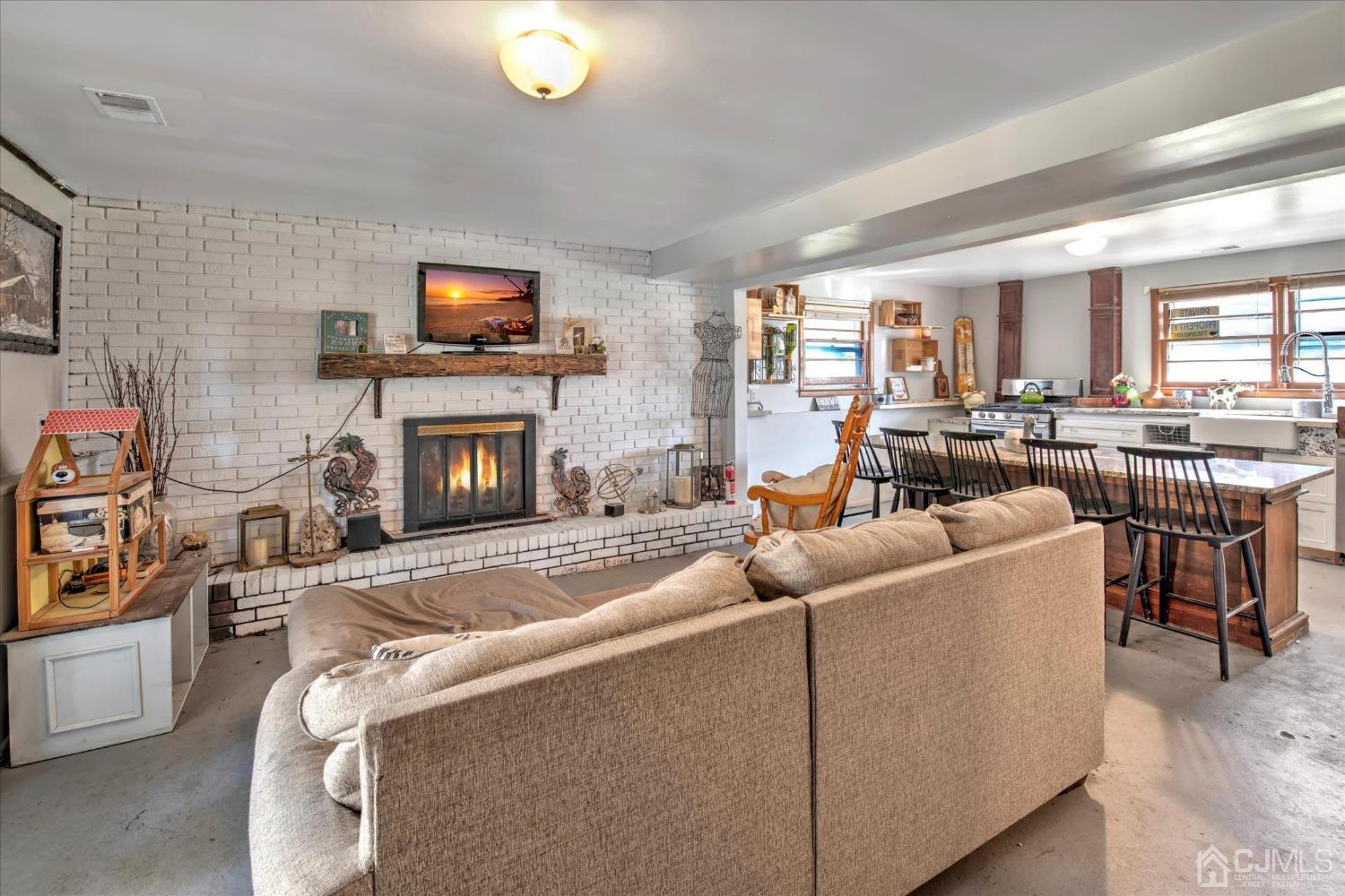 59 Sunnyside Road Howell, NJ 07731 - Photo 19 of 26 a living room with furniture and a flat screen tv