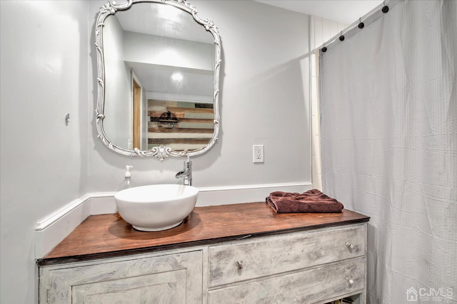 59 Sunnyside Road Howell, NJ 07731 - Photo 23 of 26 a bathroom with a sink and a mirror