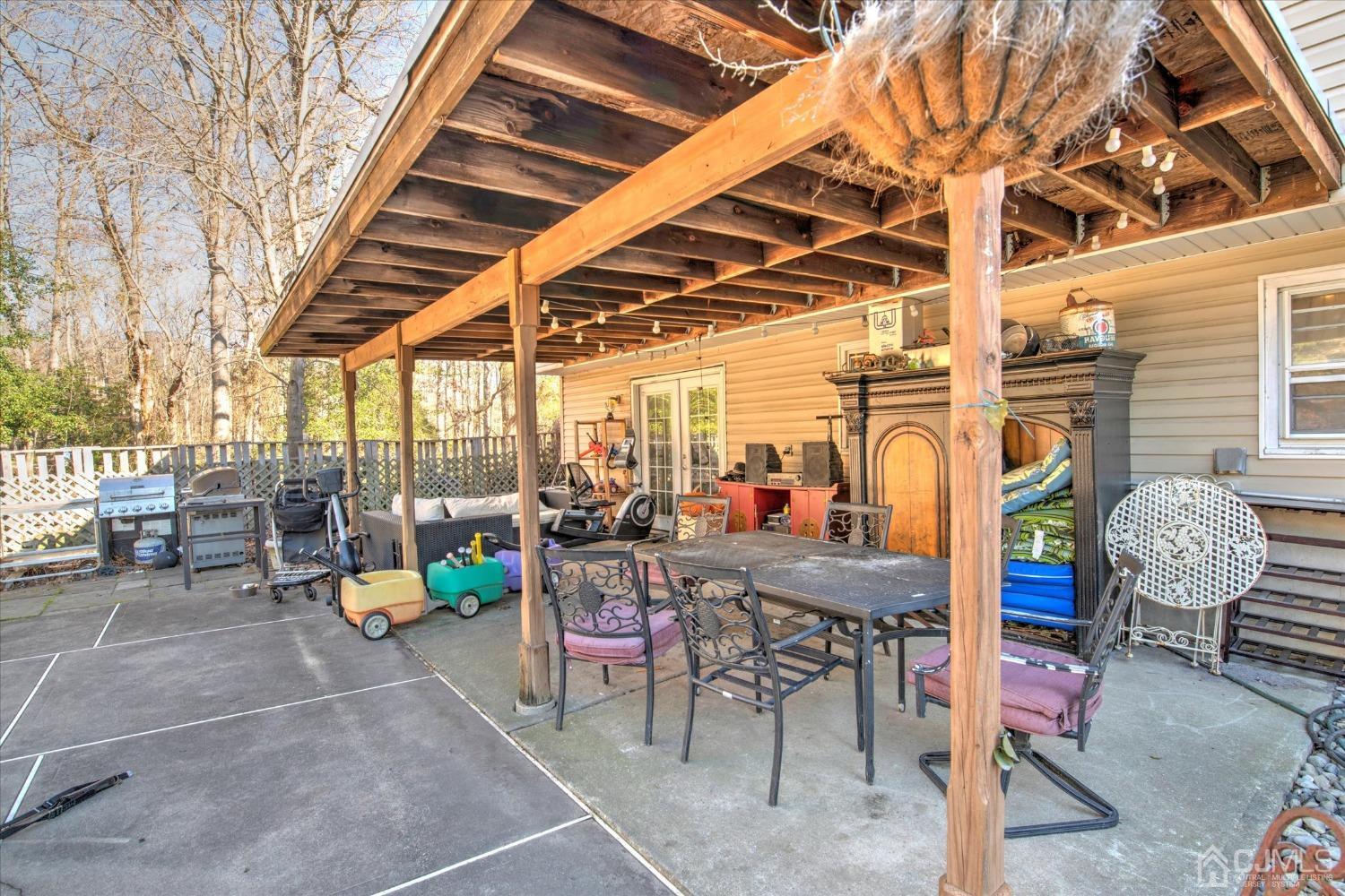 59 Sunnyside Road Howell, NJ 07731 - Photo 24 of 26 a view of a chairs tables and tables in patio