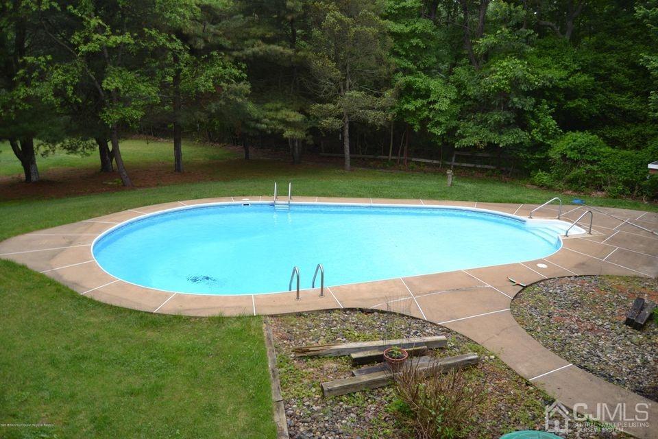 59 Sunnyside Road Howell, NJ 07731 - Photo 26 of 26 a view of a swimming pool with a yard
