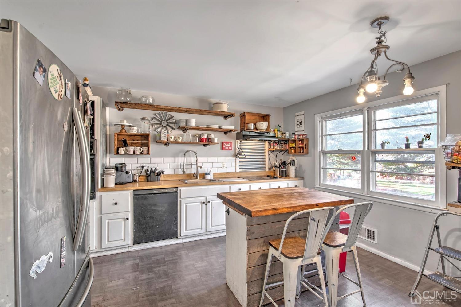 59 Sunnyside Road Howell, NJ 07731 - Photo 6 of 26 a kitchen with stainless steel appliances granite countertop a stove and a refrigerator