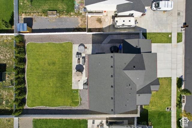 7939 Seattle Slew Road Eagle Mountain, UT 84005 - Photo 51 of 52 Expansive backyard with a manicured lawn, established landscaping, and a concrete patio