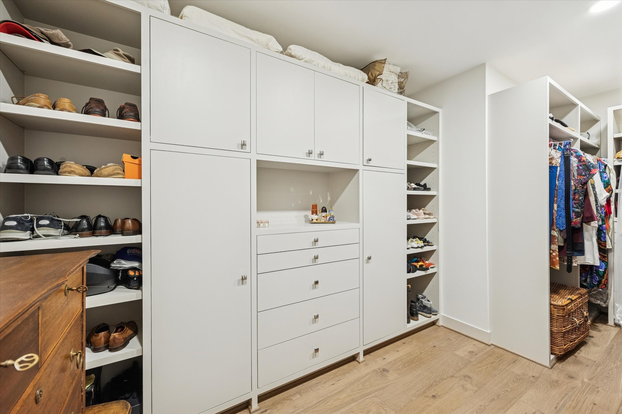 1600 Post Oak Boulevard, Unit 802 Houston, TX 77056 - Photo 11 of 19 The Primary Closet features White Oak engineered European Collection wood floors and tons of built-ins to storage/display clothes and accessories of all types and lengths.