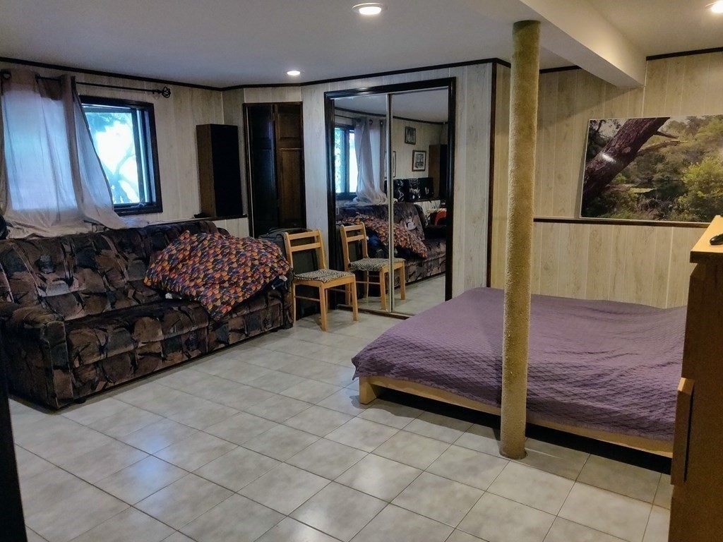 439 Massapoag Avenue Sharon, MA 02067 - Photo 11 of 22 a bedroom with a bed mirror and window