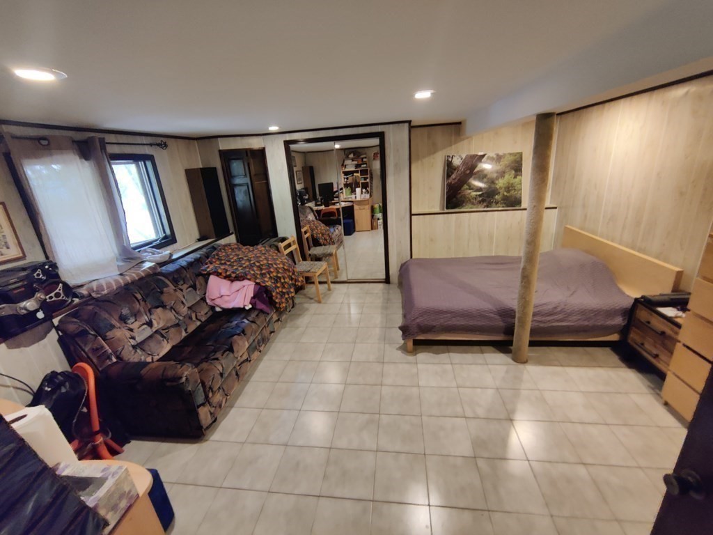 439 Massapoag Avenue Sharon, MA 02067 - Photo 12 of 22 a living room with furniture and a mirror