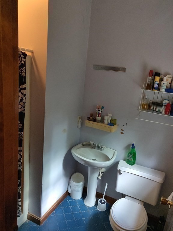 439 Massapoag Avenue Sharon, MA 02067 - Photo 13 of 22 a bathroom with a toilet a sink and a mirror