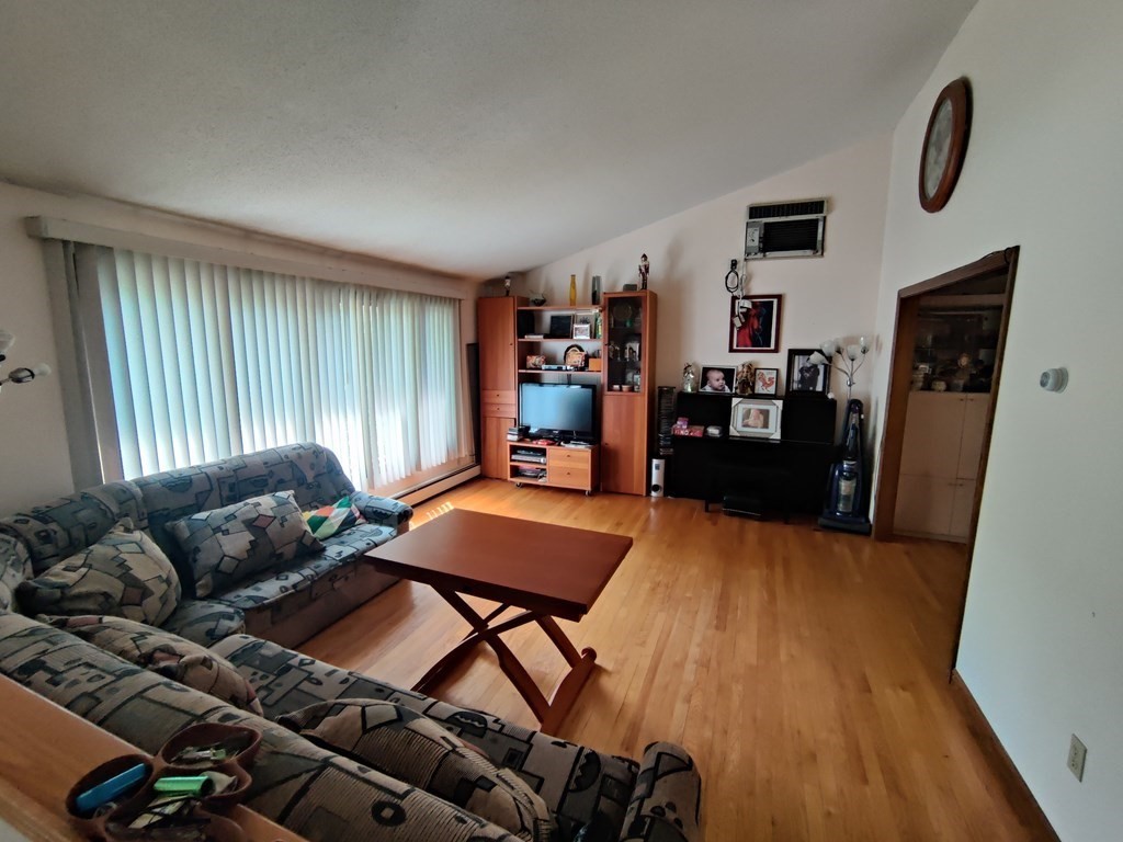 439 Massapoag Avenue Sharon, MA 02067 - Photo 4 of 22 a living room with furniture and a flat screen tv