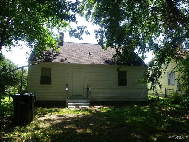 a backyard of a house with lots of green space and tree s