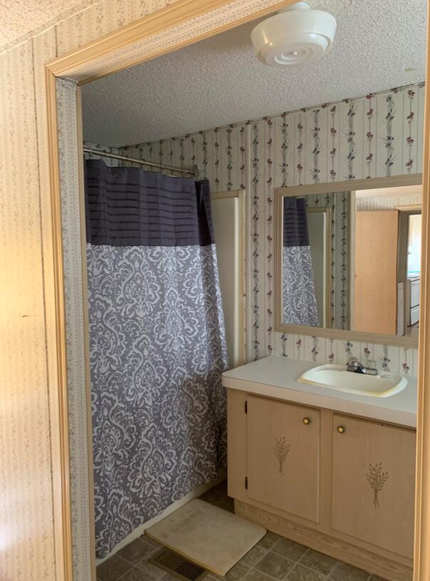 954 Valley Road Crestview, FL 32539 - Photo 10 of 17 a bathroom with a sink a mirror and shower