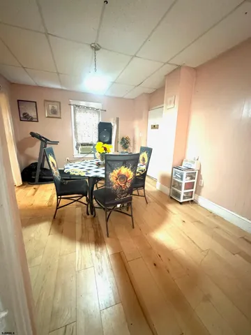 a view of a dining room with furniture and a window