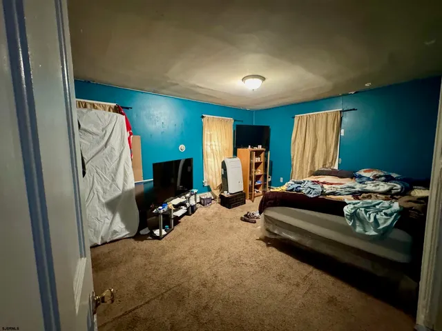 a bedroom with bed and a car parked
