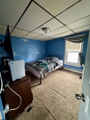 a bedroom with bed and window