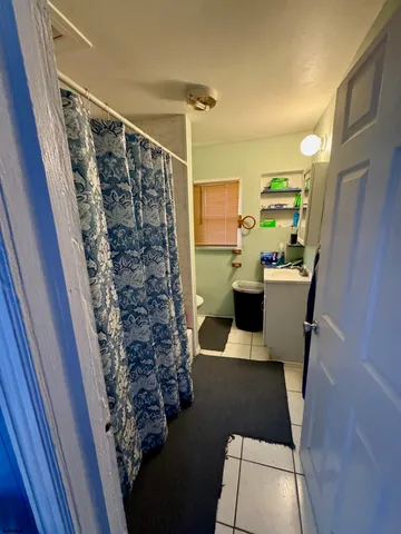 a view of a bathroom with sink and shower