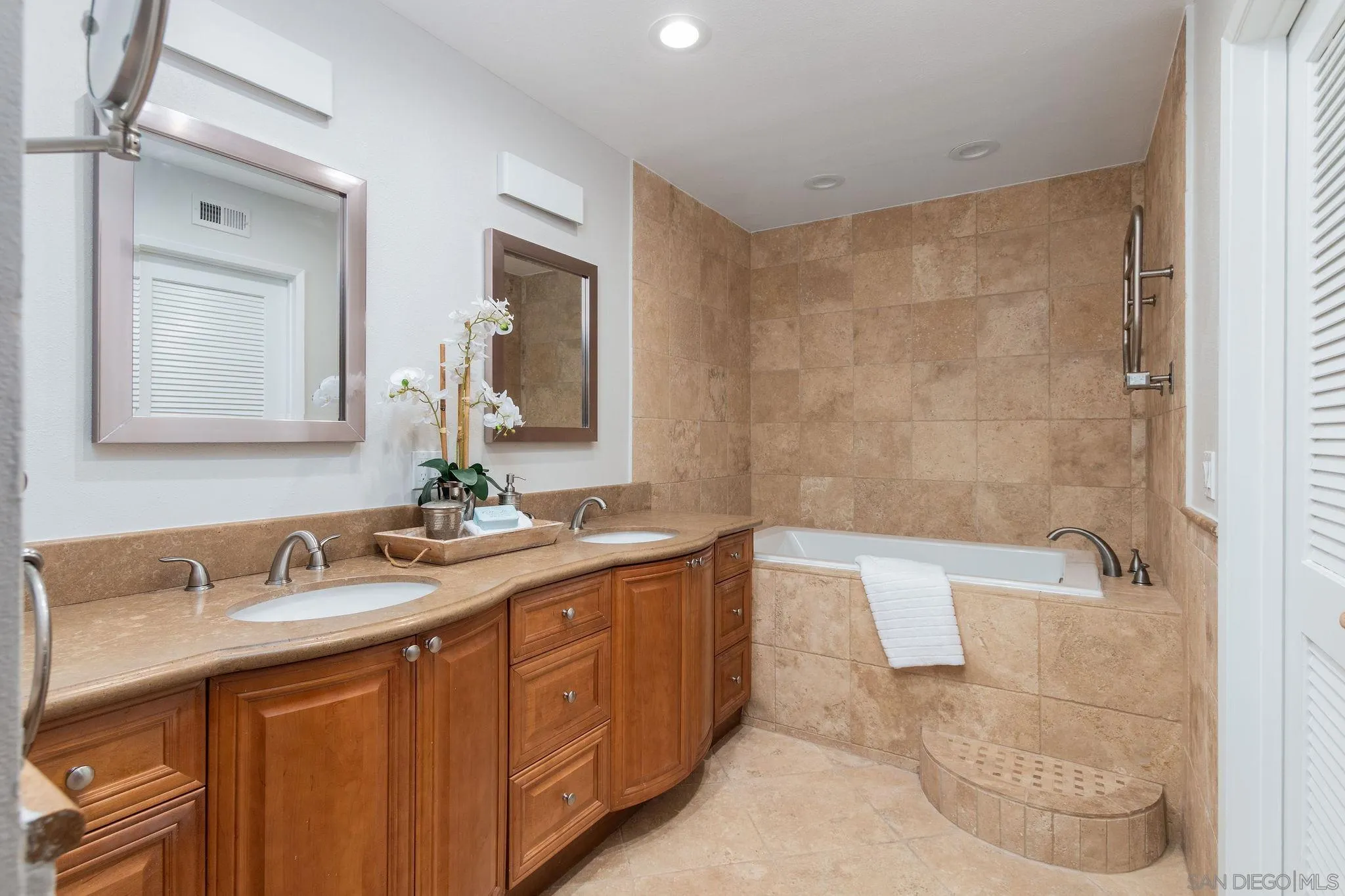 1863 Caminito Quintero La Jolla, CA 92037 - Photo 14 of 27 a bathroom with a granite countertop sink a mirror a bathtub and shower